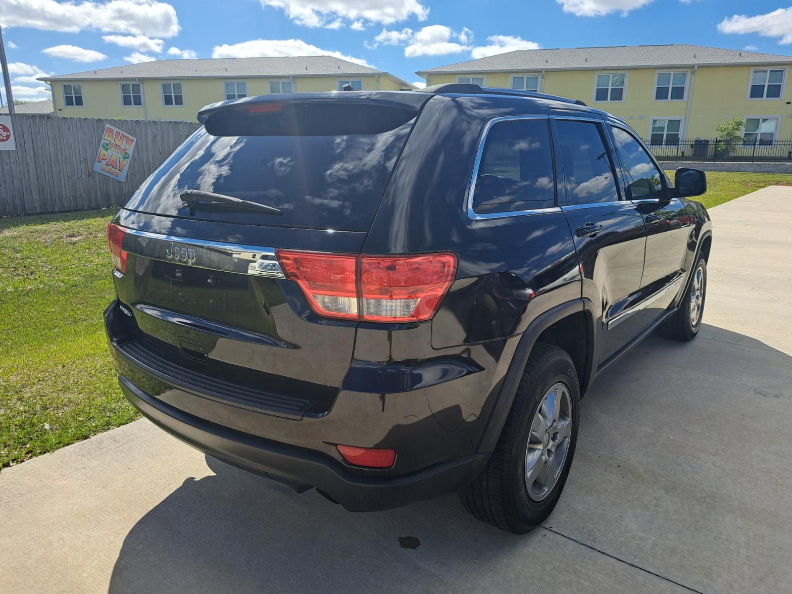 2013 Black Jeep Grand Cherokee Laredo 2WD (1C4RJEAG4DC) with an 3.6L V6 DOHC 24V engine, 5-Speed Automatic transmission, located at 1181 Aurora Rd, Melbourne, FL, 32935, (321) 241-1100, 28.132914, -80.639175 - Photo #1