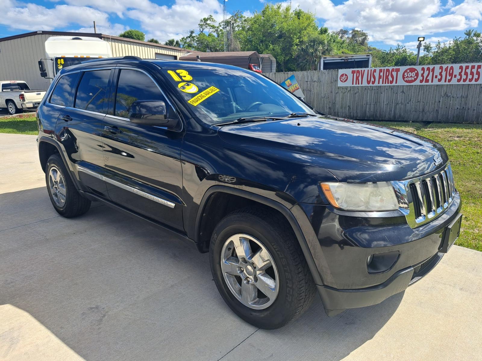 2013 Black Jeep Grand Cherokee Laredo 2WD (1C4RJEAG4DC) with an 3.6L V6 DOHC 24V engine, 5-Speed Automatic transmission, located at 1181 Aurora Rd, Melbourne, FL, 32935, (321) 241-1100, 28.132914, -80.639175 - Photo #2