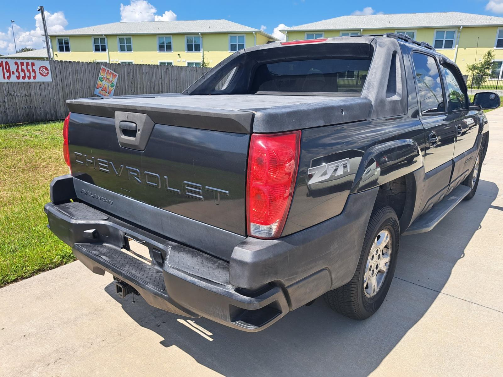 2003 Black Chevrolet Avalanche 1500 4WD (3GNEK13T03G) with an 5.3L V8 OHV 16V engine, 4-Speed Automatic Overdrive transmission, located at 1181 Aurora Rd, Melbourne, FL, 32935, (321) 241-1100, 28.132914, -80.639175 - Photo #1